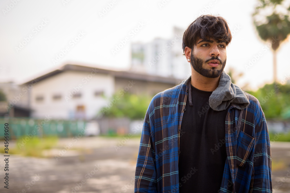 Young handsome bearded Indian hipster man in urban streets Young handsome bearded Indian hipster man in urban streets