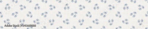 

Seamless tossed floral border pattern. French blue linen shabby chic style. Hand drawn country bloom banner. Rustic woven background. Kitchen towel home decor swatch. Simple flower ribbon trim edge.