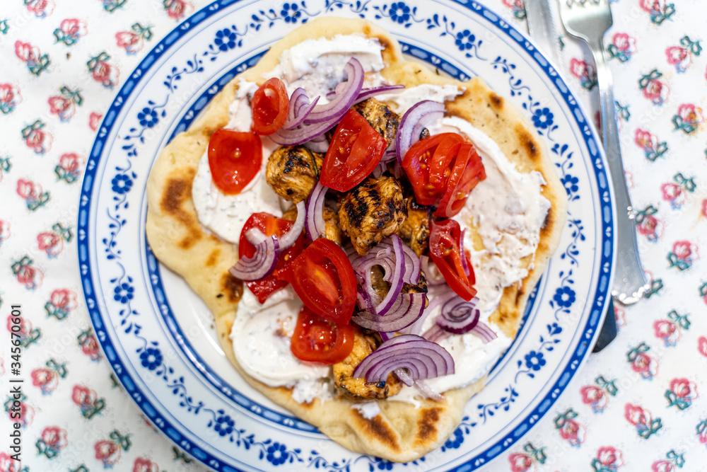 Greek Pita Chicken Souvlaki Kalamaki wrap opened with Tzatziki yogurt sauce, chicken skewers, red onion and tomato.
Traditional greek street food. Greek Pita Chicken Souvlaki Kalamaki wrap opened with Tzatziki yogurt sauce, chicken skewers, red onion and tomato.
Traditional greek street food.