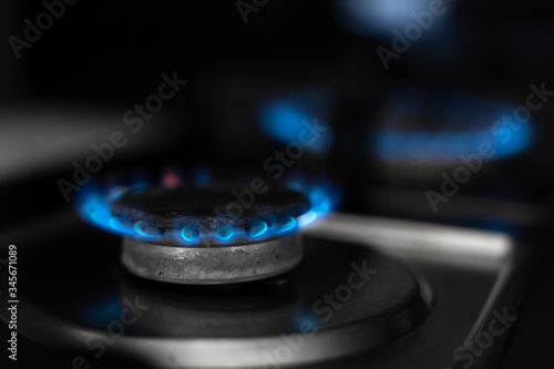 Gas stove, gas is burning. Gas burner on a dark background