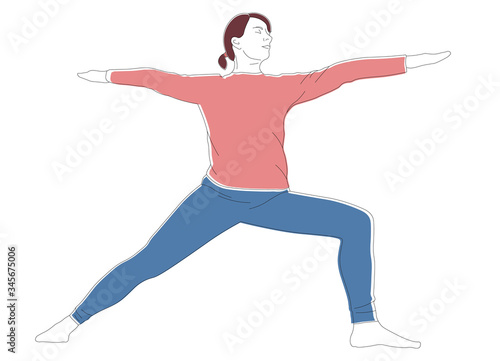 woman practices Ashtanga Vinyasa Yoga asana Virabhadrasana 2 warrior pose.