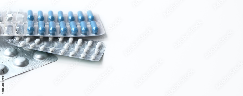 Medical topic. long banner on white background. blue and white pills in package Medical topic. long banner on white background. blue and white pills in package