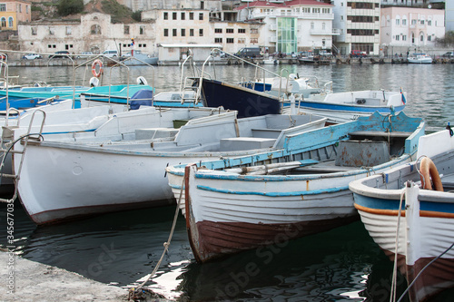 Sevastopol, Balaklava, Republic of Crimea, Russia. Moored boats and boats to the shore of Balaclava. Embankment of Balaclava © Оксана Корниенко