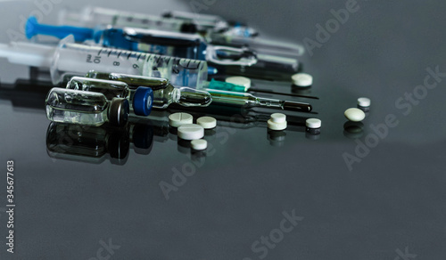 Thermometer, pills, injection vaccine ampoules, syringe for vaccination on glass background, Coronavirus, Wuhan coronavirus 2019-nCoV,concept of Corona virus quarantine,Covid-19.