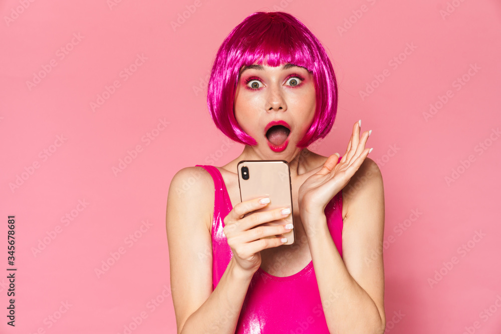Image of party girl expressing surprise and using mobile phone Image of party girl expressing surprise and using mobile phone