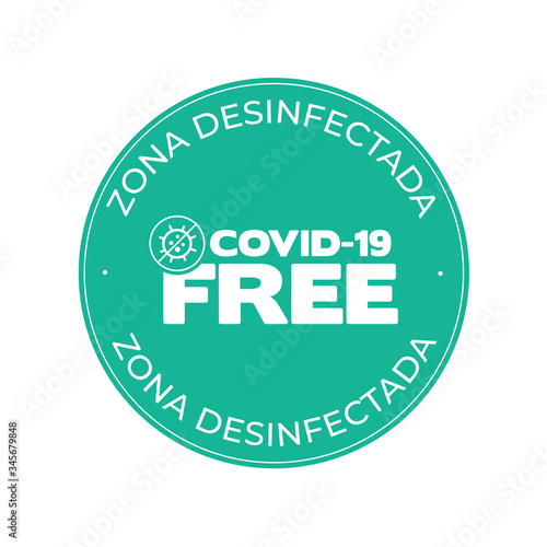 Green round sticker for disinfected areas of coronavirus. Disinfected area written in Spanish. Covid-19 free