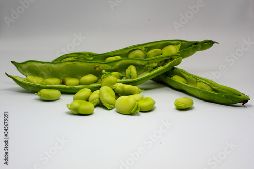 Wallpaper Mural panoramic of open green broad beans in their shells and some shelled beans isolated on a white background Torontodigital.ca