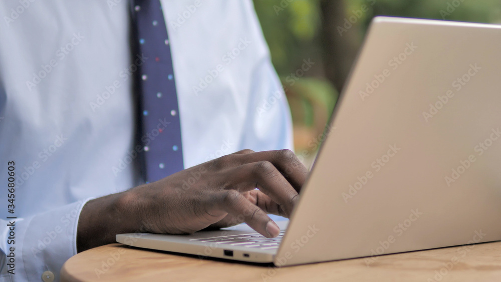 African Businessman Hands Typing on Laptop - obrazy, fototapety, plakaty 