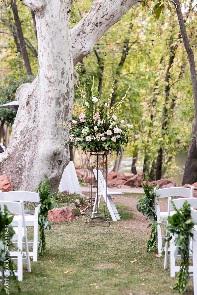 wedding ceremony aisle with chairs and flowers