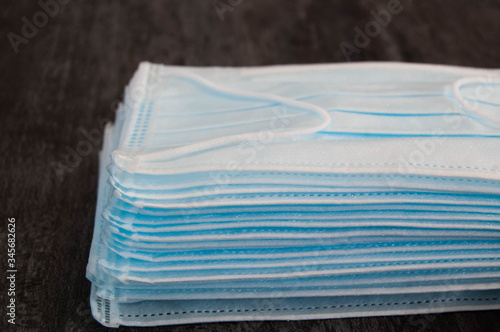 Medical disposable mask, horizontal photo with copy space and grey background. A pack of medical masks close-up.