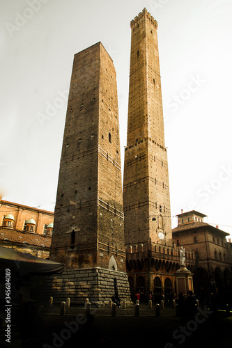 Two of most famous towers in Bologna, Italy: Torre degli Asinelli and the Torre Garisenda. Asinelli tower was built in the 11th century. It is over 97 metres tall, making it the tallest in Italy. photo