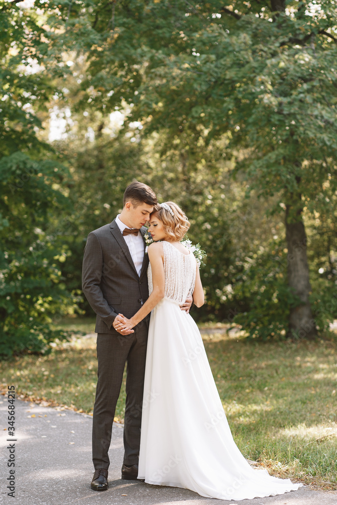 Bride and groom. Portrait of a man in a suit and a woman of a blonde in a white dress on nature on the wedding day. Bride and groom. Portrait of a man in a suit and a woman of a blonde in a white dress on nature on the wedding day.