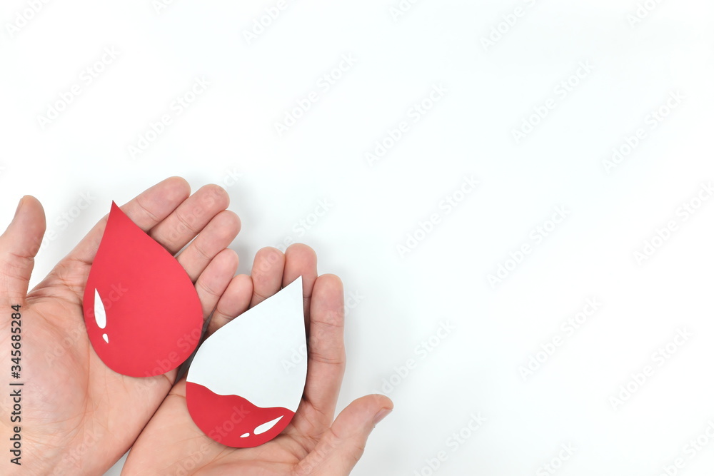 Male hands holding blood drop. Donation and transfusion concept. World Blood Donor Day.