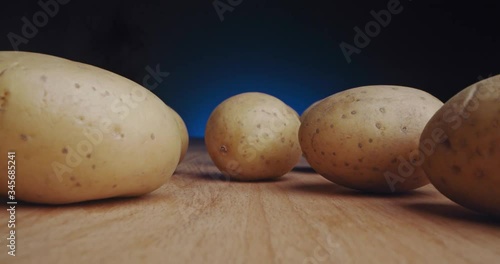 un cooked potato potatoes on a wood table