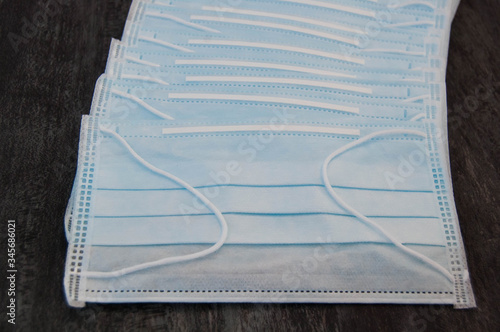 Medical disposable masks, horizontal photo with grey background. A pack of medical masks close-up.