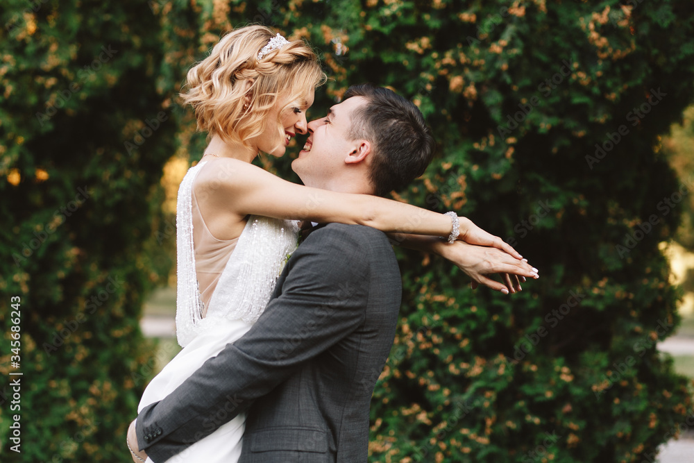 Bride and groom. Portrait of a man in a suit and a woman of a blonde in a white dress on nature on the wedding day. Bride and groom. Portrait of a man in a suit and a woman of a blonde in a white dress on nature on the wedding day.