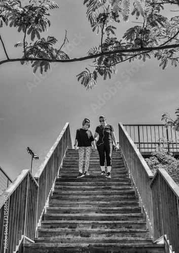 The Mother And Her 12-year-old Daughter Complying With The Schedules To Go For A Walk  Wearing A Mask Sanitary After The State Of Alarm. Covid-19 Bull Run Pandemic In Spain.