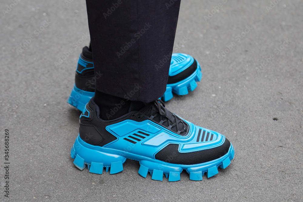 Man with black and blue Prada Cloudbust Thunder sneakers on September 22,  2019 in Milan, Italy Stock Photo | Adobe Stock