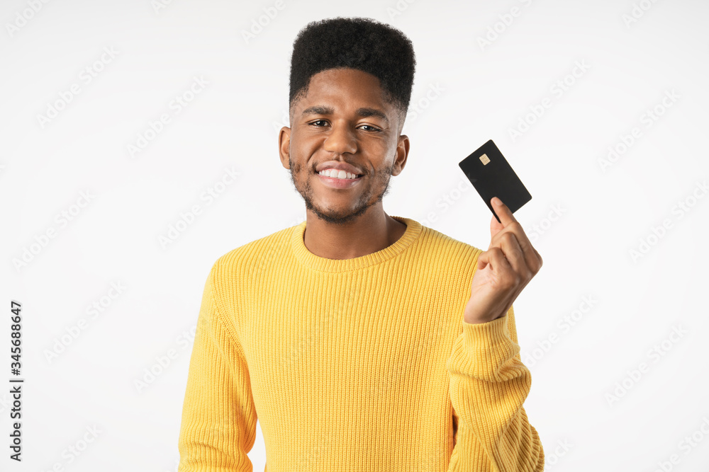 Portrait of happy african man wearing sweater showing credit card standing isolated over white background Portrait of happy african man wearing sweater showing credit card standing isolated over white background