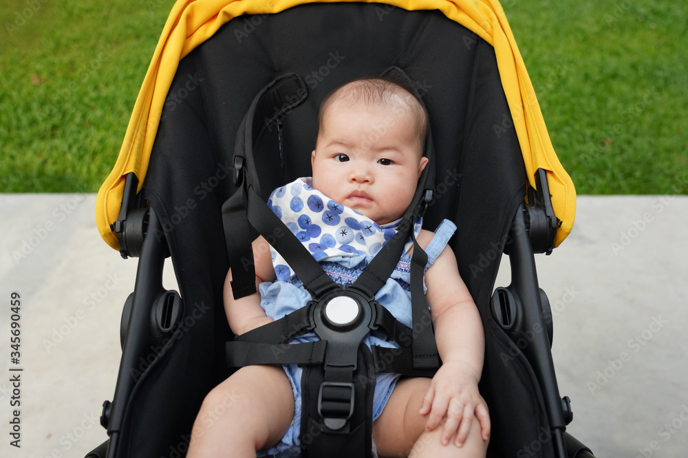 Asian baby inside stroller