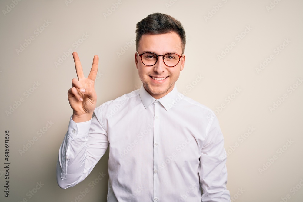 Young handsome business mas wearing glasses and elegant shirt over isolated background showing and pointing up with fingers number two while smiling confident and happy. Young handsome business mas wearing glasses and elegant shirt over isolated background showing and pointing up with fingers number two while smiling confident and happy.