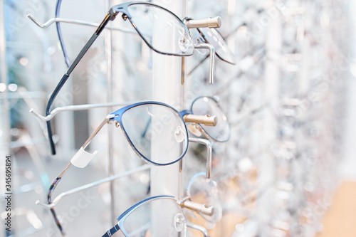 Eyeglasses sorted in line on shelf at optical shop