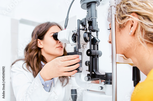Fototapeta Naklejka Na Ścianę i Meble -  Optometrist giving Slit lamp examination of the eyes in ophthalmology clinic