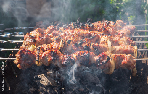 Shish kebab. Pork or lamb meat pieces being fried on a charcoal grill. Frying grilled pieces of meat during the rest.