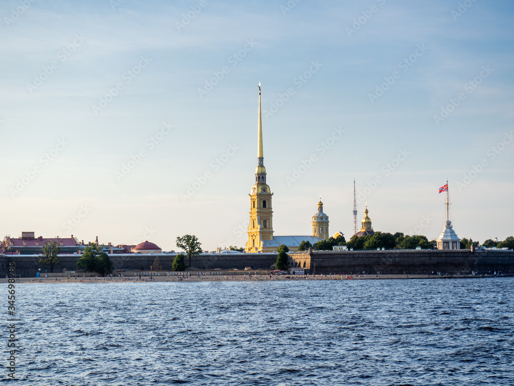 Peter and Paul Fortress illuminated by the sun against a blue sky
