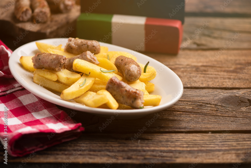 White plate of italian sausage and potatoes White plate of italian sausage and potatoes