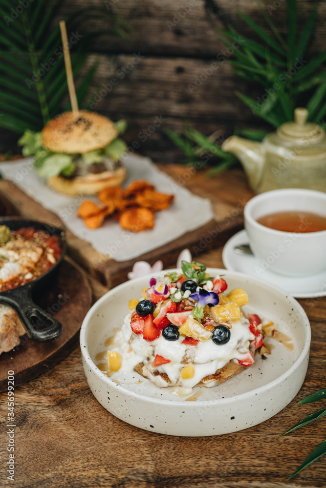 Fototapeta premium Dinner with gamburger, shakshuka and pancakes and coffee