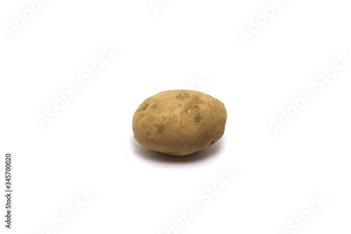 An unpeeled potato  Solanum tuberosum  shot on top high angle isolated on white background