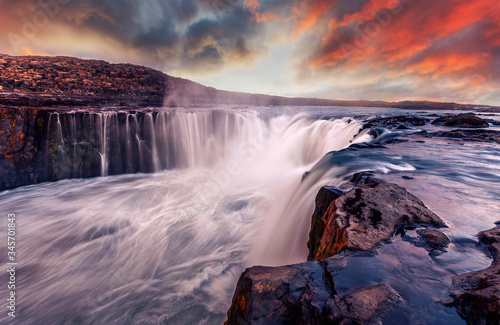 Iceland scenery during sunset. Awesome nature landscape. powerfull Waterfall with colorful sky during sunset. Iconic location for landscape photographers. Selfoss waterfall. creative image