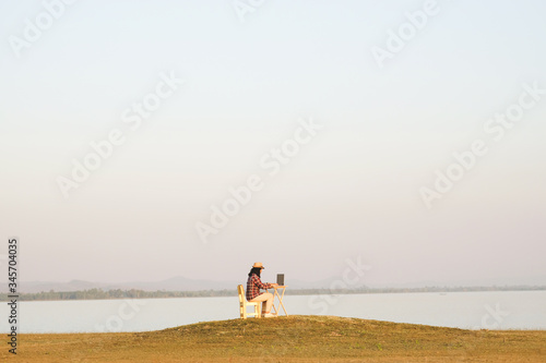 Fényképezés Businesswoman working on laptop is outside in early morning, she is young and attractive girl