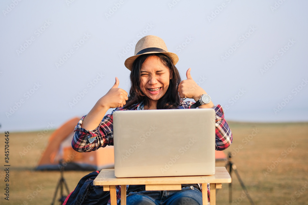 Businesswoman working on laptop is outside in early morning, she is young and attractive girl. Work from anywhere lifestyle. Freedom, freelance