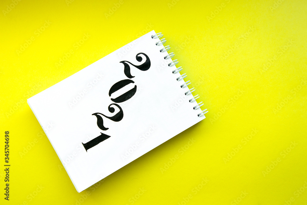 Notebook with white pages on yellow background. Notebook with text 2021. Targets for future year Notebook with white pages on yellow background. Notebook with text 2021. Targets for future year