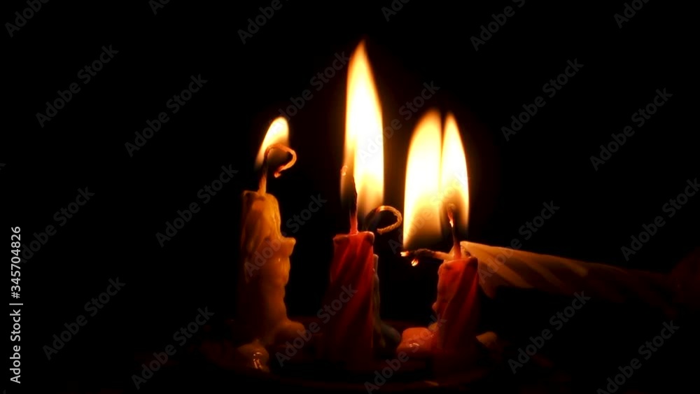 Close Up Few Burning Candles on a Black Background in Slow Motion. Dramatic Scene of Melted Wax at Night. After Party Candlelight Close Up Few Burning Candles on a Black Background in Slow Motion. Dramatic Scene of Melted Wax at Night. After Party Candlelight