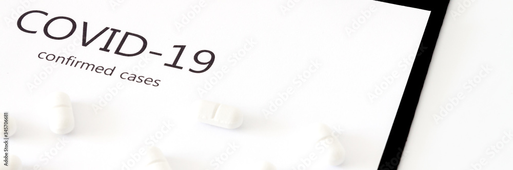 White scattered pills on a white background. Coronavirus. Panorama White scattered pills on a white background. Coronavirus. Panorama