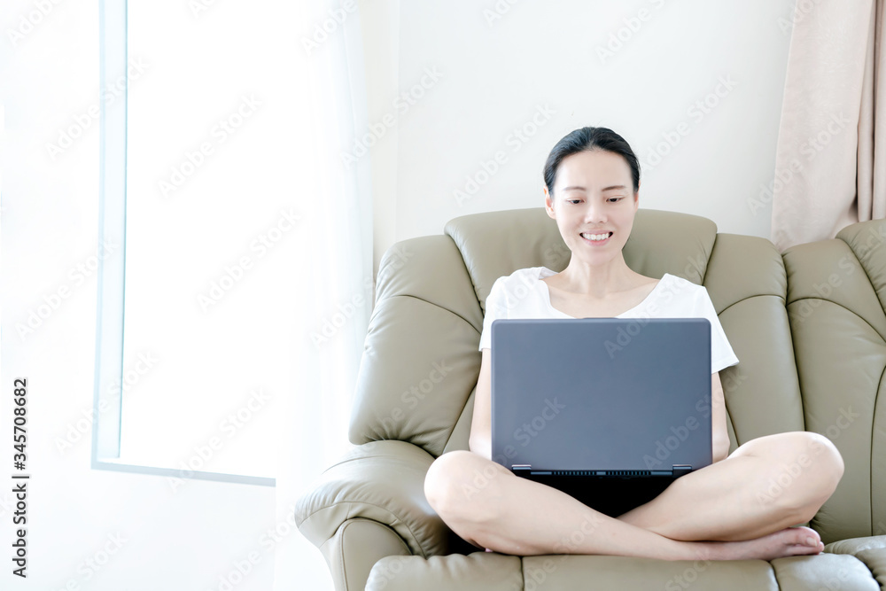 Young beautiful woman using a laptop at home Young beautiful woman using a laptop at home