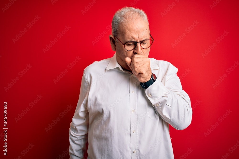 Middle age handsome hoary man wearing casual shirt and glasses over red background feeling unwell and coughing as symptom for cold or bronchitis. Health care concept.