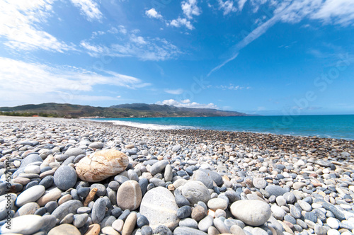 Cretan beach at Kolymvari, saturated. The pebbly beach is in the sun. A light wind blows the vacationers' faces. The island of Crete has many faces.