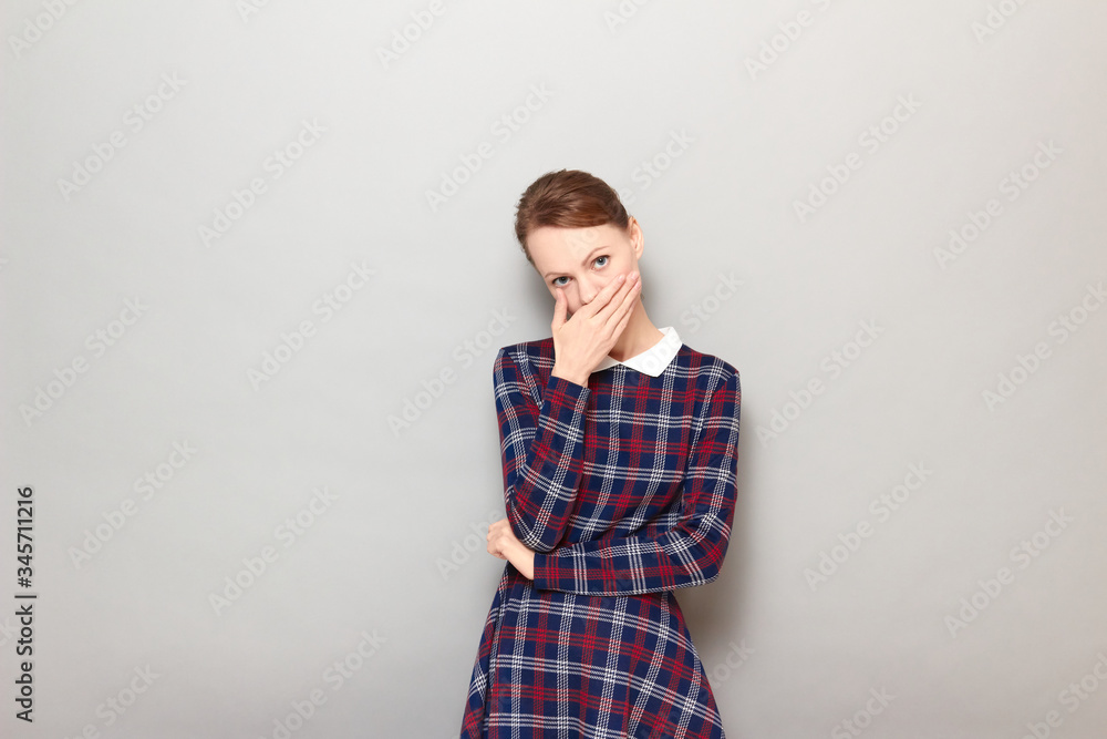 Portrait of sad unhappy girl covering mouth and being ready to cry Portrait of sad unhappy girl covering mouth and being ready to cry