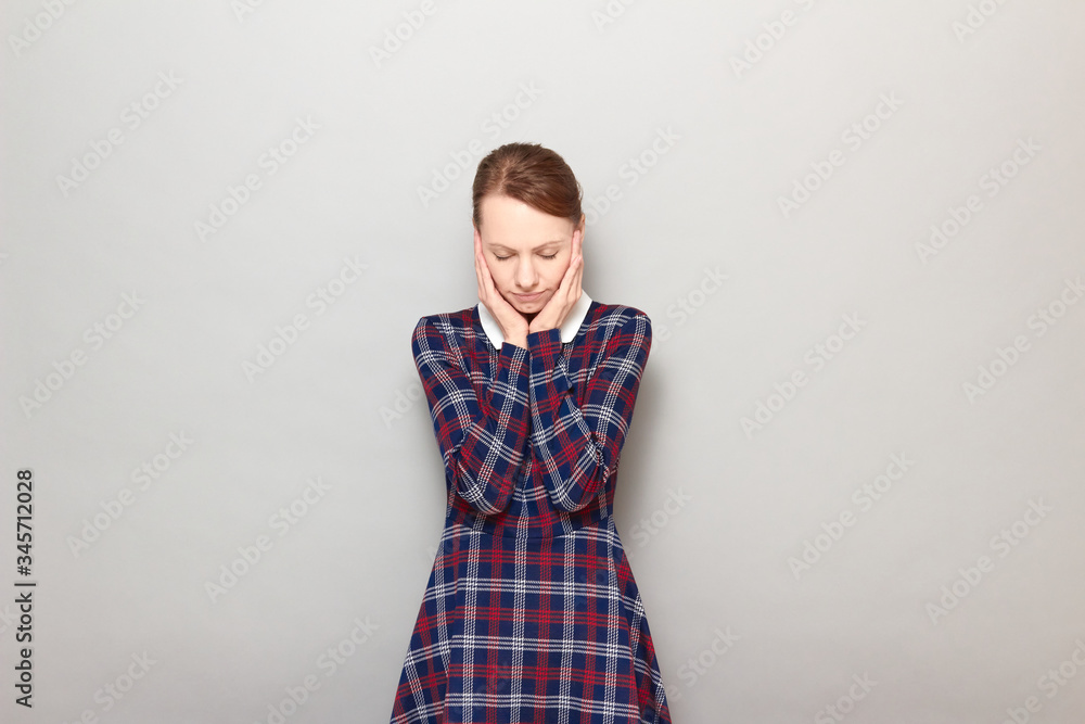 Portrait of unhappy young woman touching cheeks with hands Portrait of unhappy young woman touching cheeks with hands