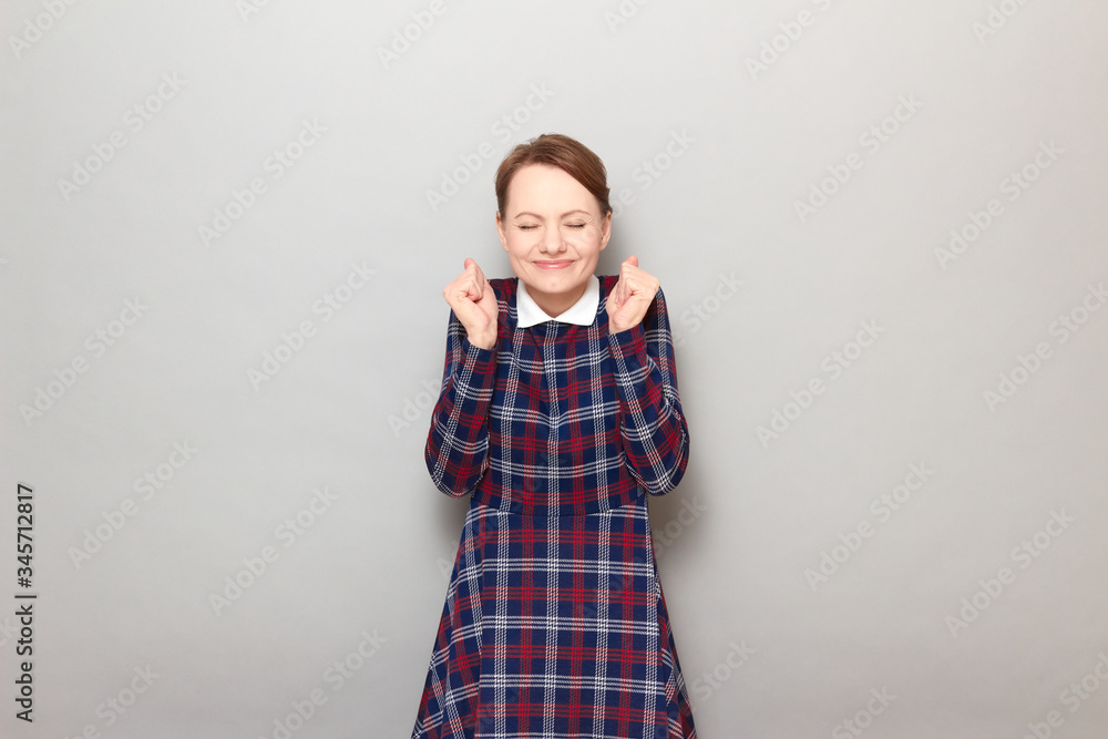 Portrait of happy overjoyed girl raising fists up in triumph Portrait of happy overjoyed girl raising fists up in triumph