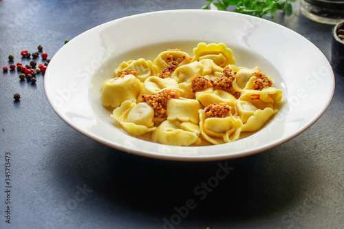 tortellini, pasta with filling (ravioli or dumplings)
second course
Menu concept. food background. top view copy space for text