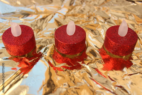Three Red flat top artificial candles