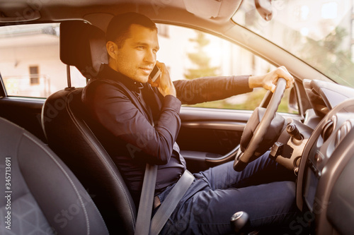 A man is sitting in a car. Vehicle interior. Businessman driving