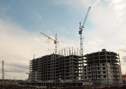 multi-storey buildings under construction, construction cranes, Sunny day