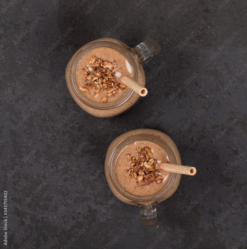 Smoothies from dried fruits, prunes, raisins, nuts in a jar with bamboo straws on a dark background top view Smoothies from dried fruits, prunes, raisins, nuts in a jar with bamboo straws on a dark background top view
