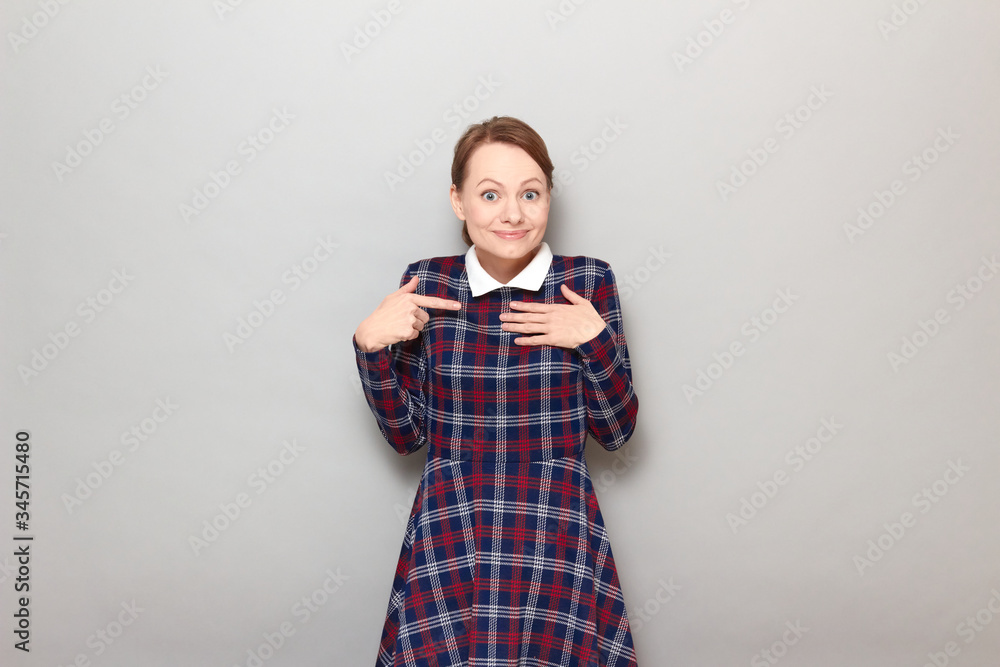 Portrait of happy girl pointing at herself and asking to select her Portrait of happy girl pointing at herself and asking to select her